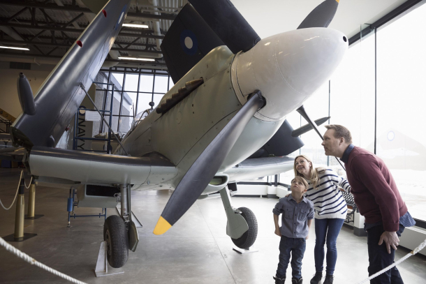 family looking at a plane at The Military Museums