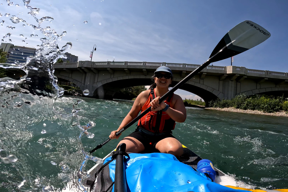 Girl paddling down the bow river downtown Calgary
