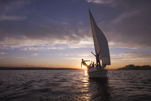 Group of people sailing at sunset on Glenmore Reservoir in Calgary, TA