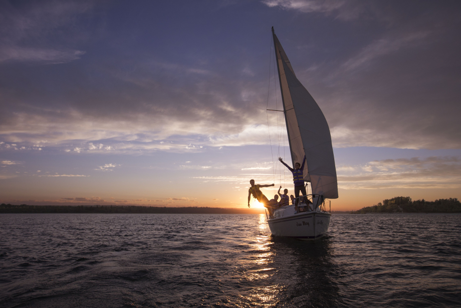 Group of people sailing at sunset on Glenmore Reservoir in Calgary, TA