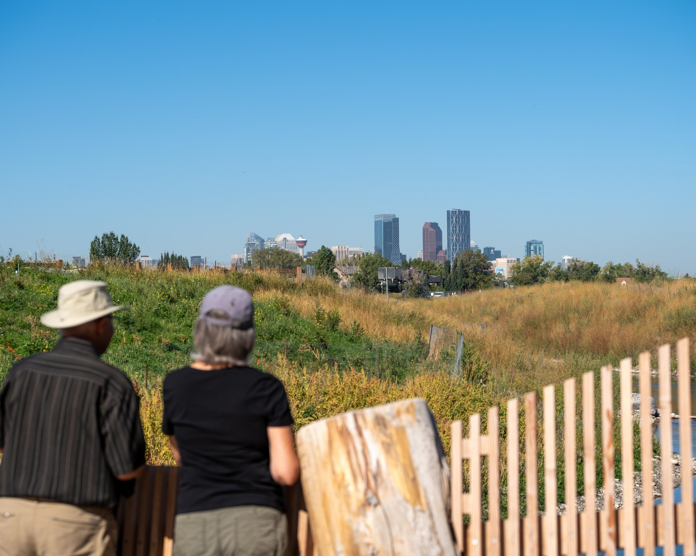 Two people looking at the skyline of calgary.