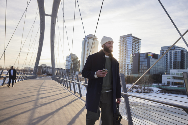 Man walking across bridge in east village