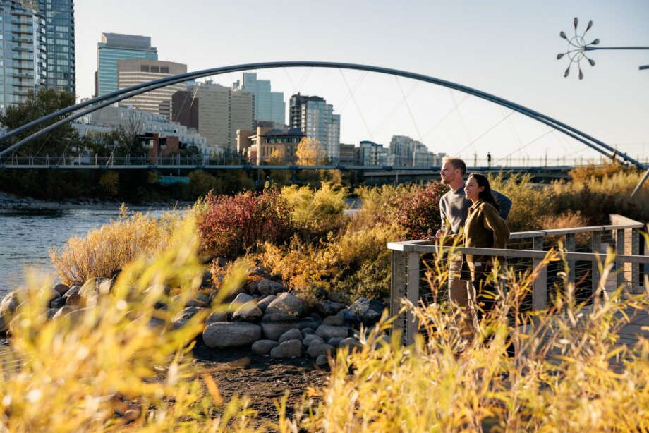 A couple looks out over the Bow River from a viewpoint on St. Patrick's Island.