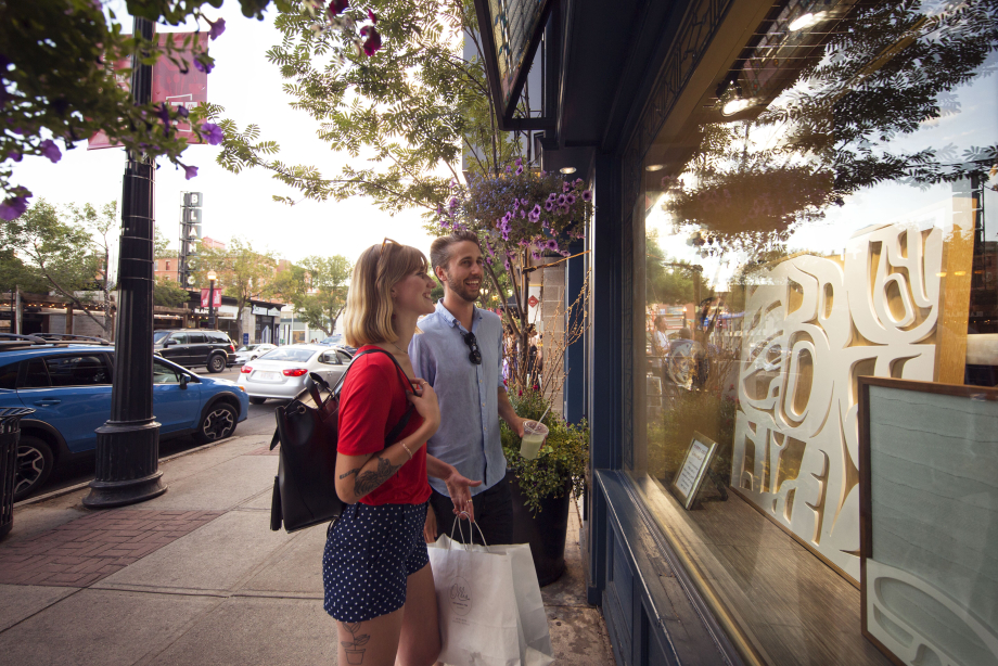 Couple shopping in front of an indigenous art gallery in downtown Calgary on 17th Ave