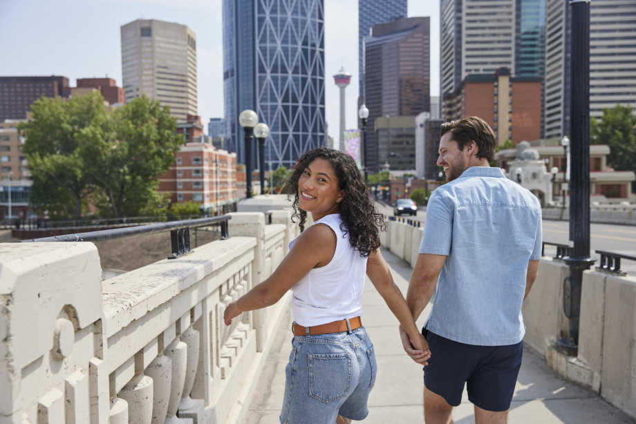 A couple walking hand in hand on Centre Street Bridge