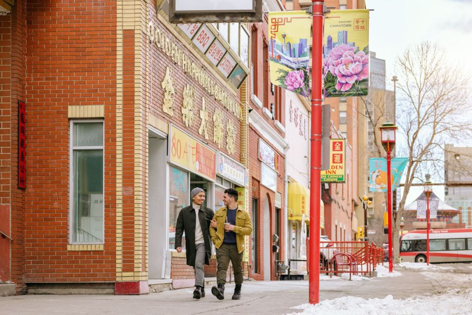 Couple walking down the street in Chinatown in downtown Calgary in winter