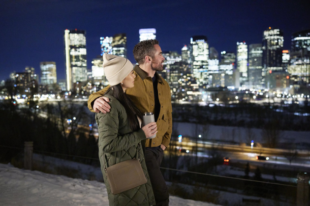 couple walking along Crescent Road admiring the skyline at night during winter