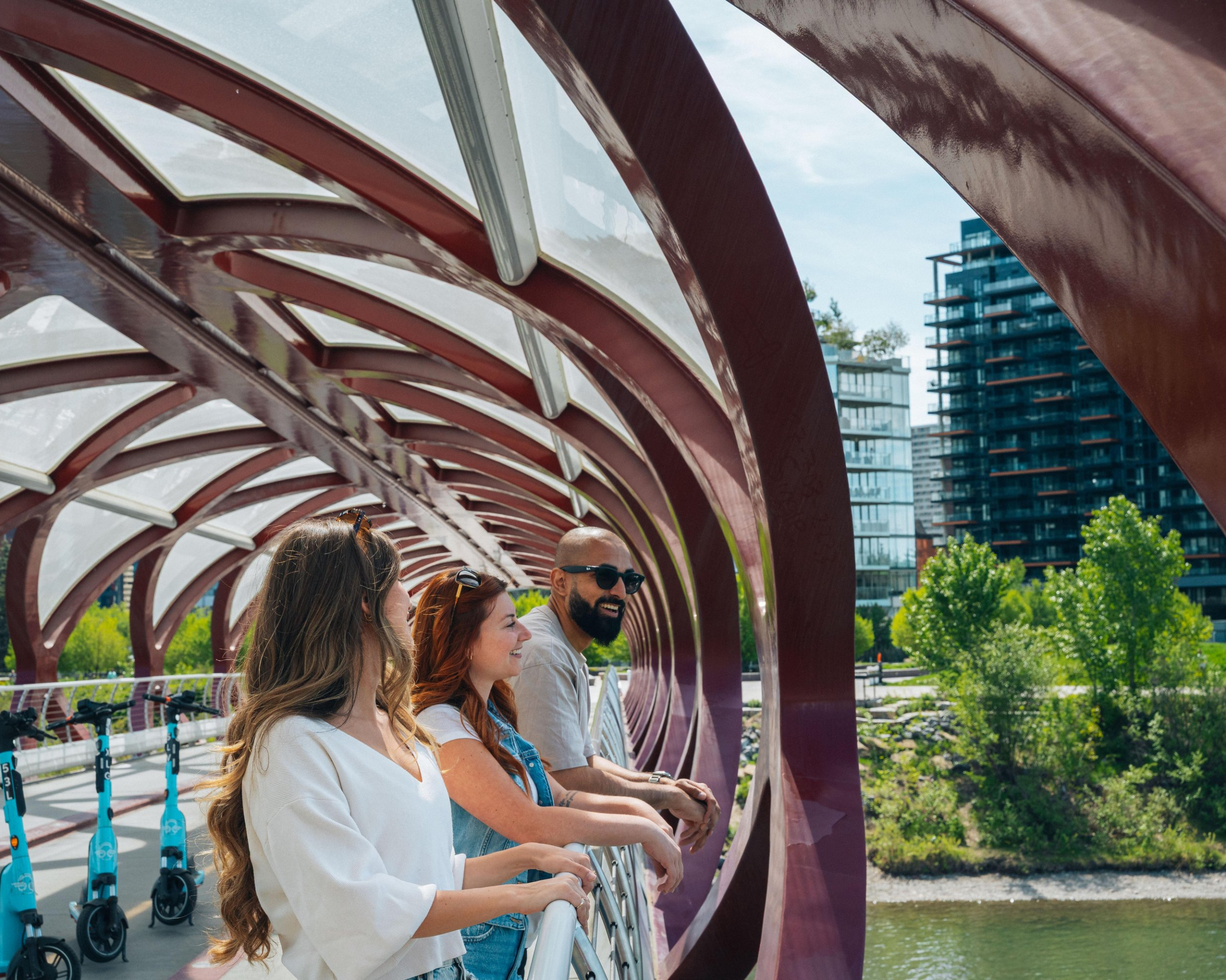 friends leaning over and looking over the Peace Bridge