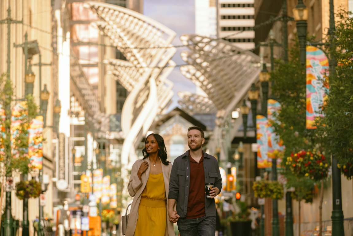 Couple walking down Stephen Ave in downtown Calgary