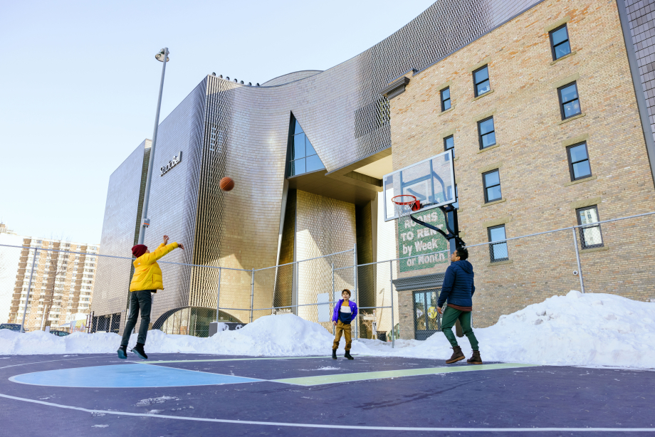 Kids playing basketball at The Bounce outdoor court in downtown Calgary