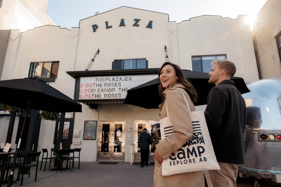 A couple stands outside The Plaza Theatre in Kensington.