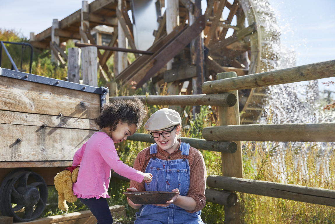 Interpreter at Heritage Park with a little girl