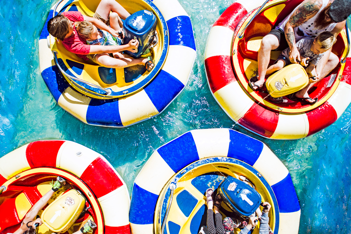 Aerial view of 4 families riding bumper boats