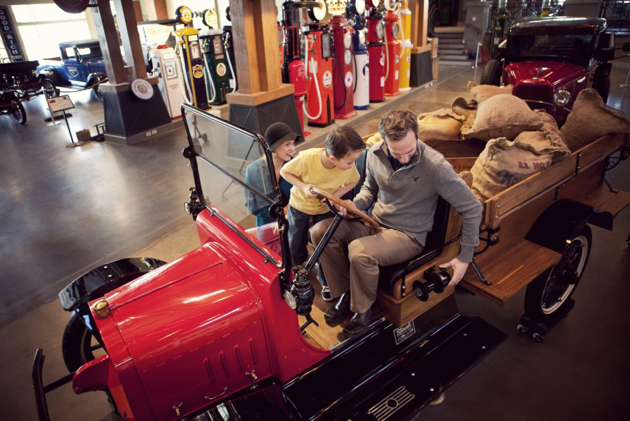 family experiencing a car at the Gasoline Alley Museum Heritage Park