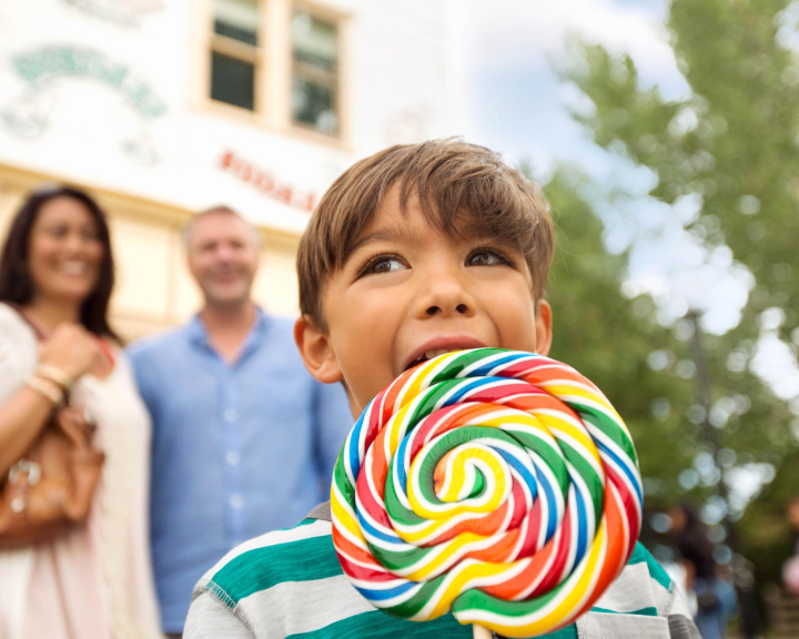 a kid with a big lollipop at Heritage Park