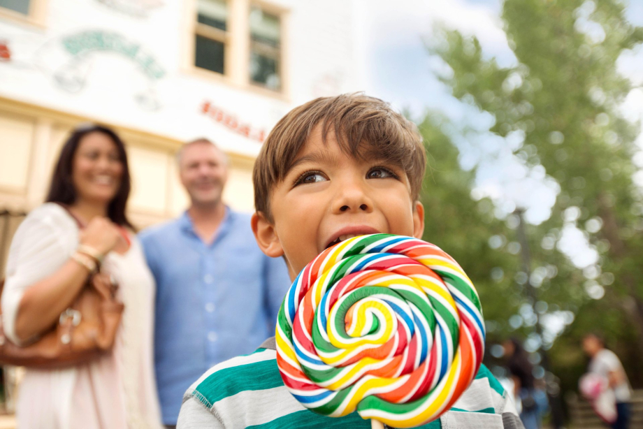 a kid with a big lollipop at Heritage Park