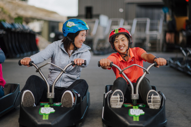 Mother and son sitting in downhill karts