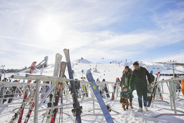 family walking around the ski racks at winsport