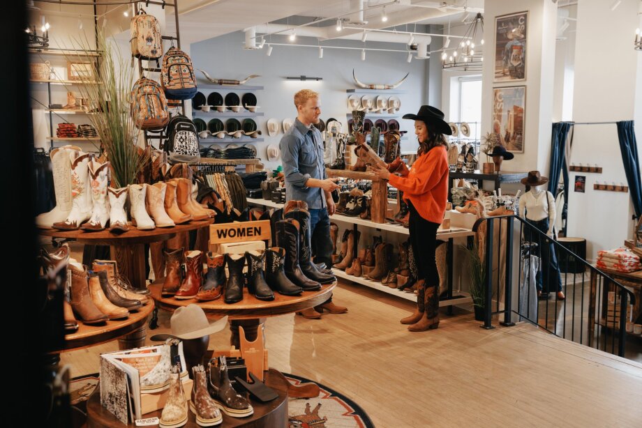 A man and a woman shopping for boots at Alberta Boot Co.