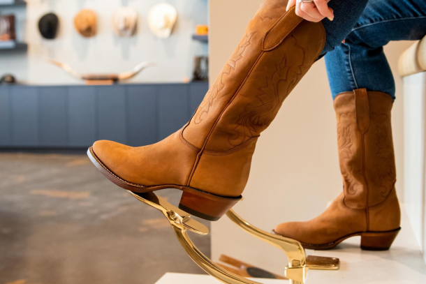 a woman fitting a custom pair of boots from Alberta Boot Company Outfitters