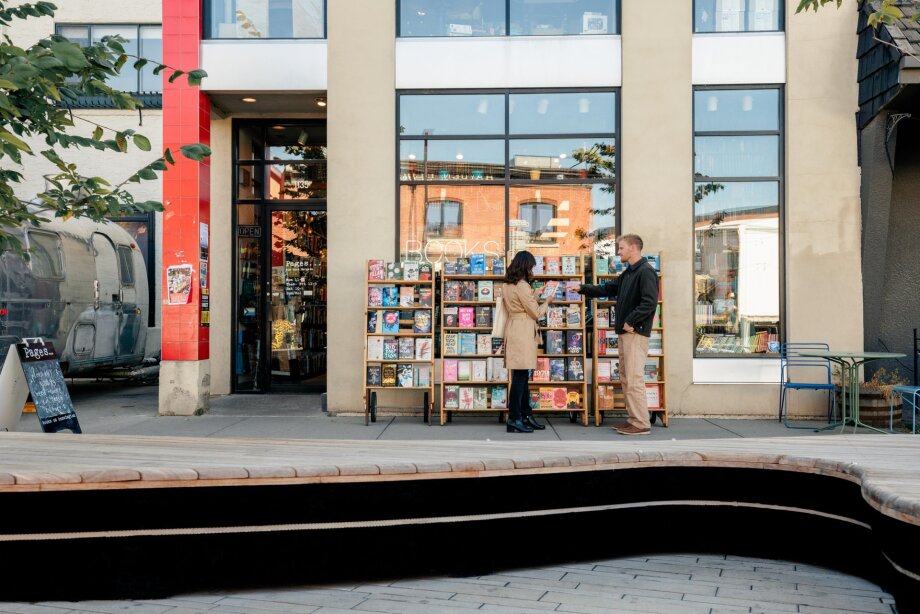 A man and a woman shopping for books outside Pages.