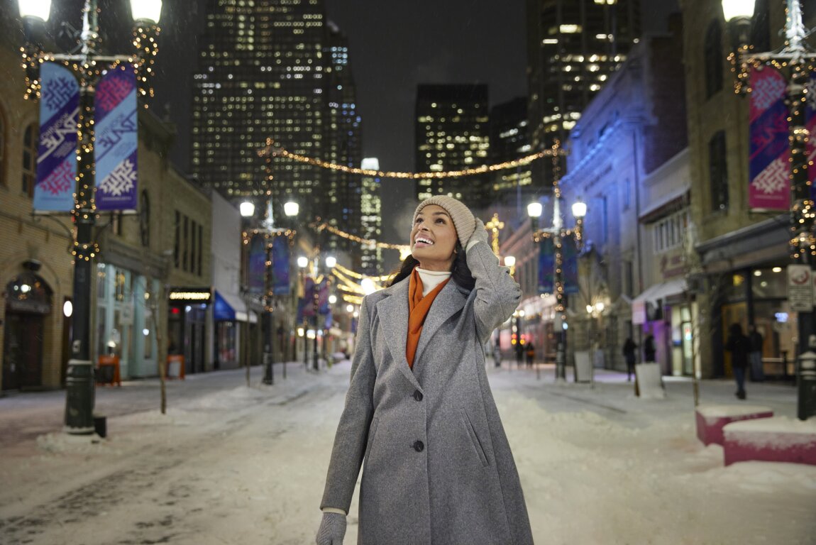 A woman walking on Stephen Ave in the winter