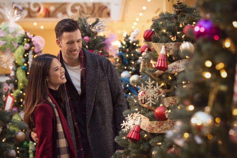 Couple standing and looking at a Christmas tree