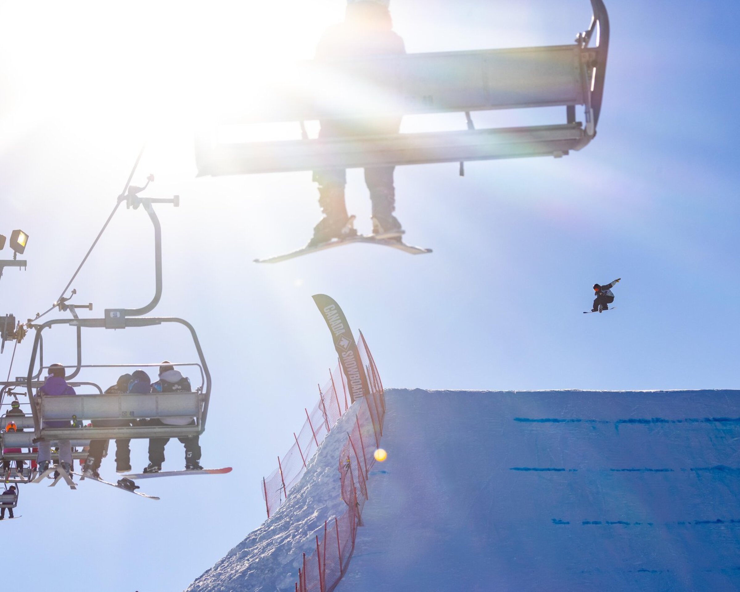 Skier riding a chairlift at WinSport