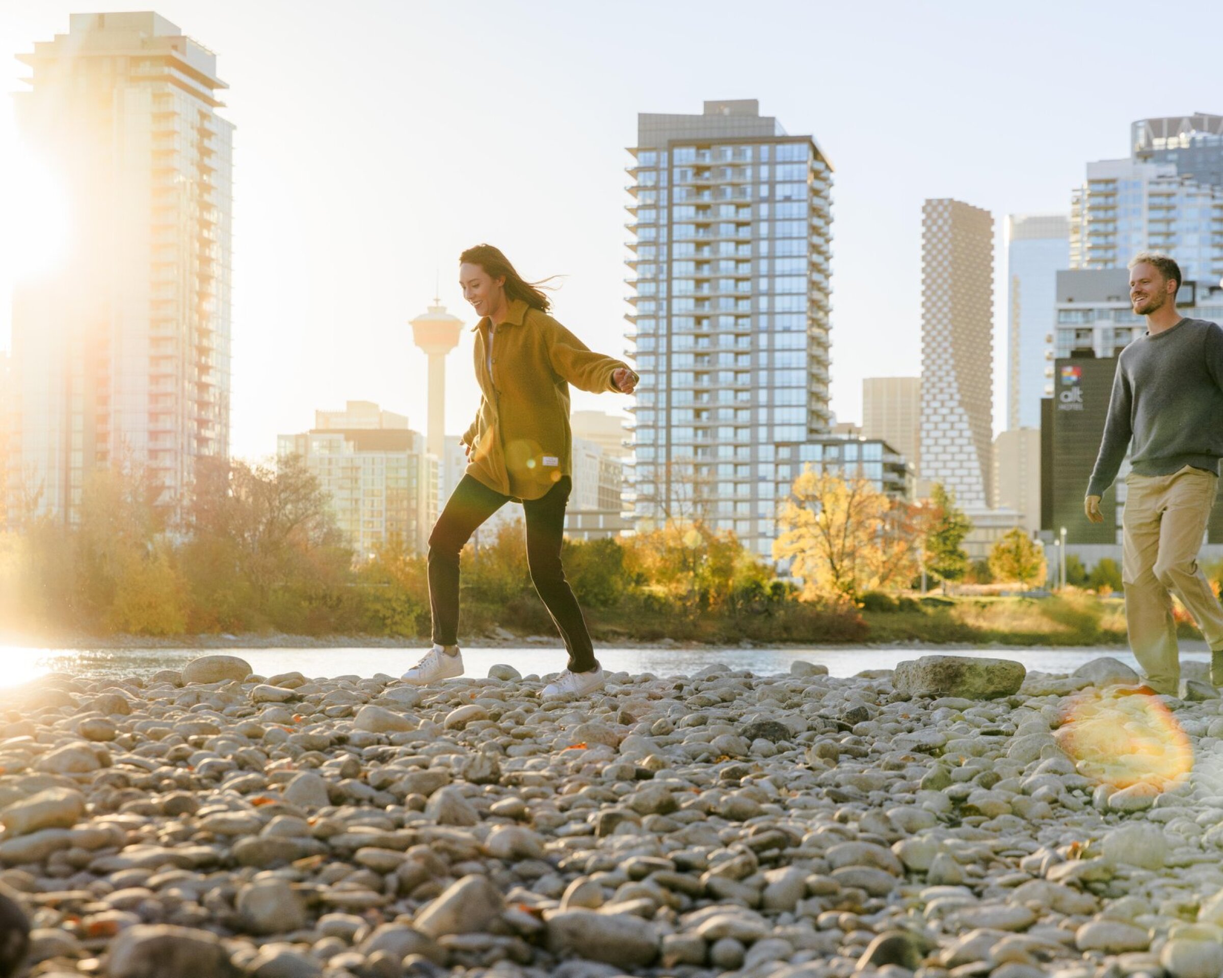 man and woman walking by the river