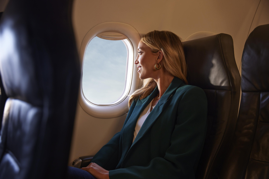 Business woman flying in an airplane