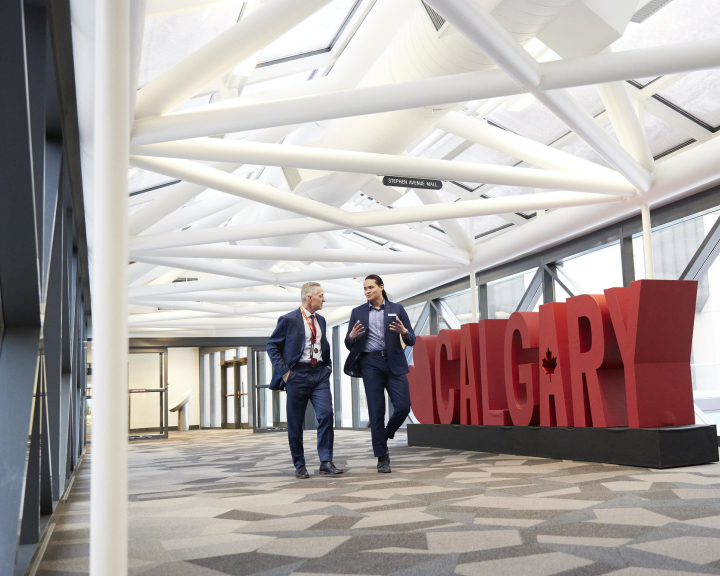 two men walking in the Calgary TELUS Convention Centre